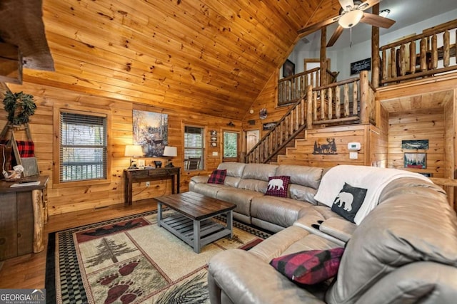 living room with hardwood / wood-style flooring, wood ceiling, and wooden walls