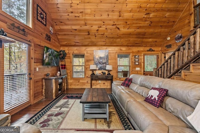 living room with a healthy amount of sunlight, dark wood-type flooring, wood ceiling, and wooden walls