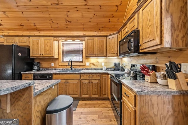 kitchen featuring sink, dark stone counters, black appliances, wooden ceiling, and light wood-type flooring