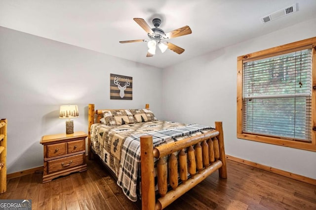 bedroom featuring dark hardwood / wood-style floors and ceiling fan