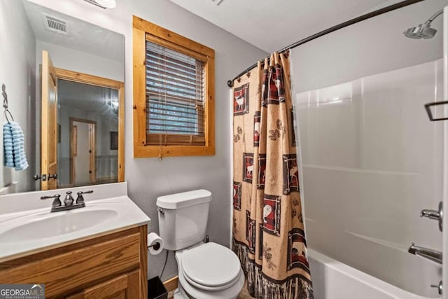 full bathroom with vanity, shower / tub combo with curtain, and toilet