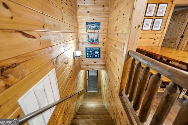 stairs featuring wooden walls