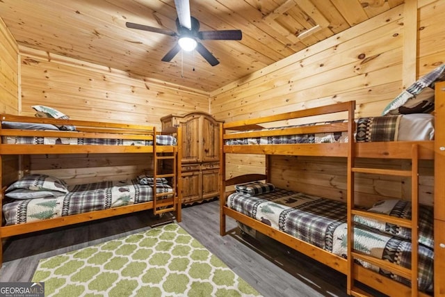 bedroom with wood ceiling, wood-type flooring, and wood walls