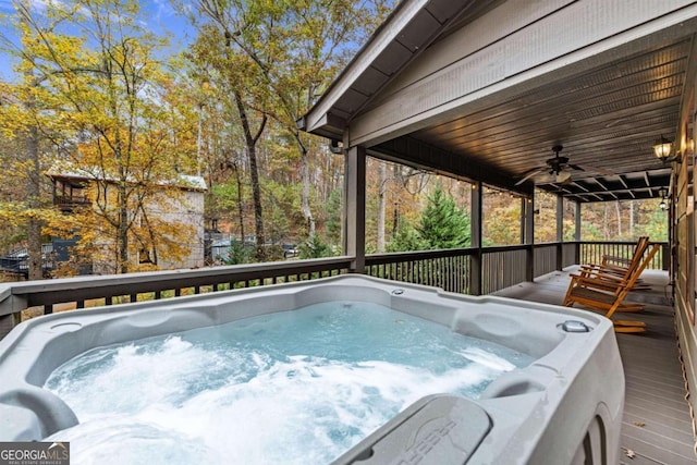 view of pool with a hot tub, a deck, and ceiling fan