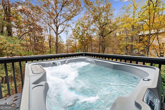 view of swimming pool with a hot tub