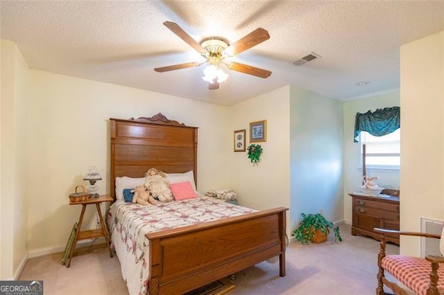 carpeted bedroom featuring a textured ceiling and ceiling fan