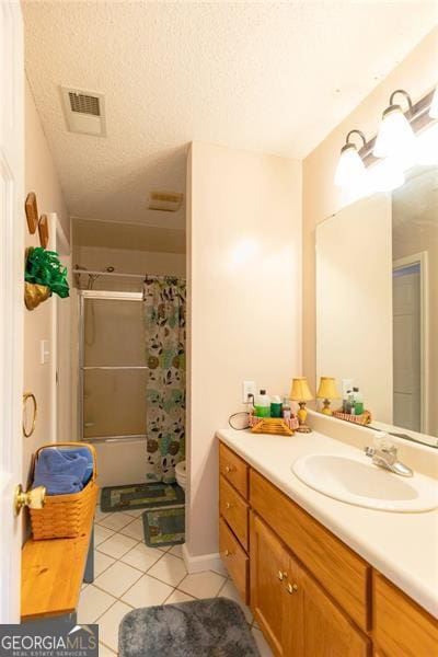 full bathroom featuring tile patterned floors, toilet, a textured ceiling, vanity, and shower / tub combo