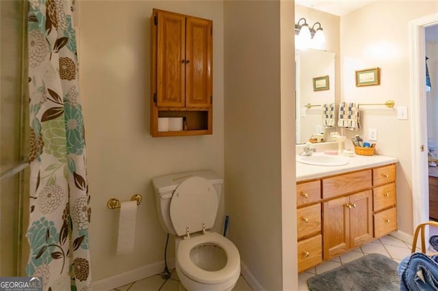 bathroom featuring vanity, tile patterned floors, and toilet