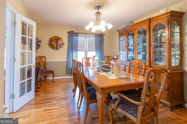 dining room with a chandelier and light hardwood / wood-style floors