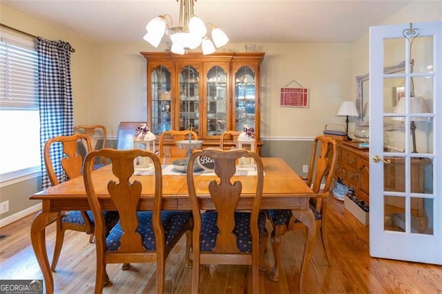 dining room with an inviting chandelier and light hardwood / wood-style floors