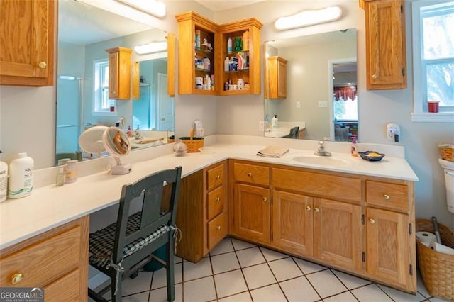 kitchen featuring light tile patterned floors, sink, and kitchen peninsula