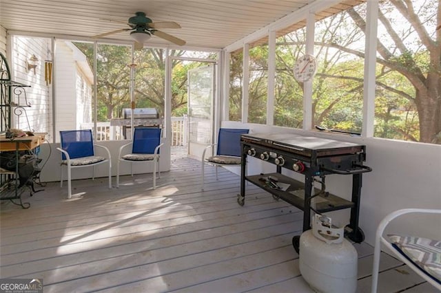 sunroom featuring a healthy amount of sunlight and ceiling fan