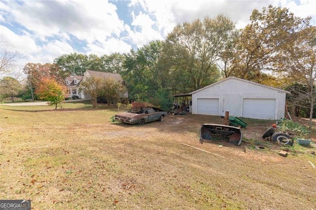 view of yard with a garage and an outdoor structure