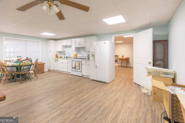 kitchen with white cabinetry, sink, white appliances, ceiling fan, and light hardwood / wood-style flooring