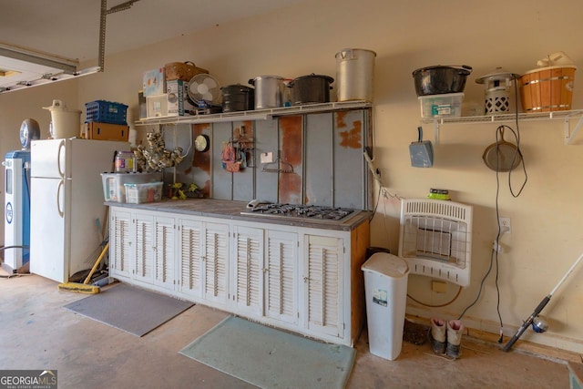 miscellaneous room with concrete flooring and heating unit