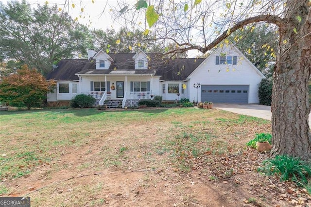 cape cod-style house featuring a garage, covered porch, and a front lawn