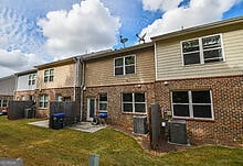 back of house with a yard and a patio