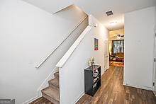 stairway with hardwood / wood-style floors