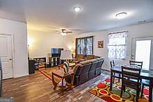 living room featuring hardwood / wood-style flooring and ceiling fan