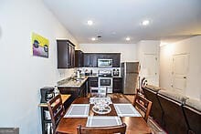 kitchen featuring stainless steel appliances and dark brown cabinets