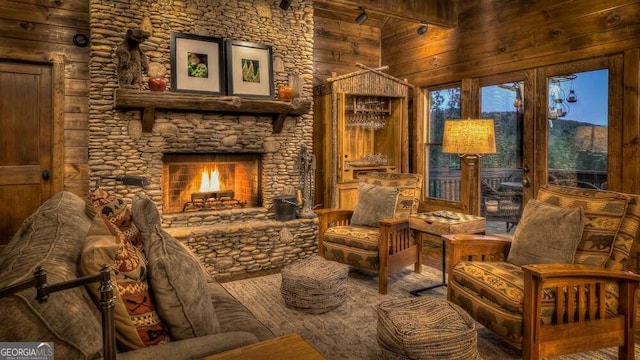 living area featuring beam ceiling, a fireplace, a towering ceiling, and wood walls