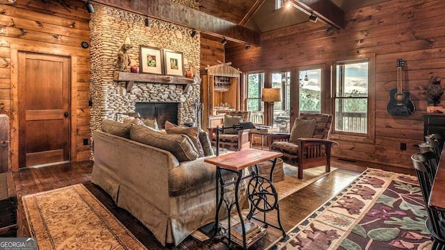 living room featuring a stone fireplace, dark hardwood / wood-style floors, high vaulted ceiling, and beamed ceiling