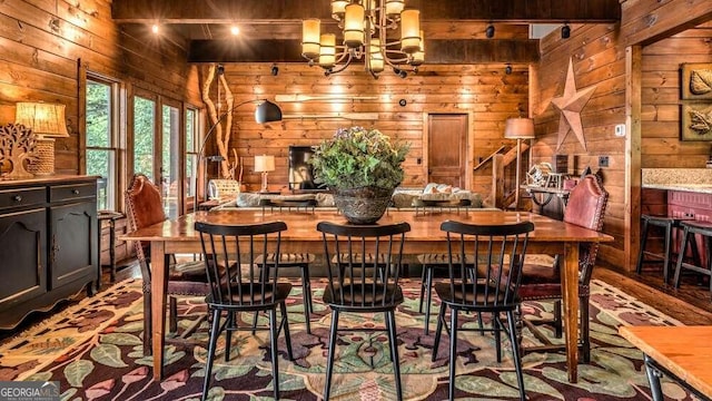 dining area featuring an inviting chandelier, beamed ceiling, and wooden walls