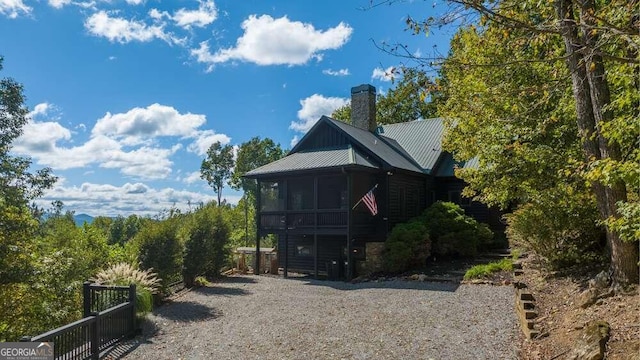 back of property with a sunroom