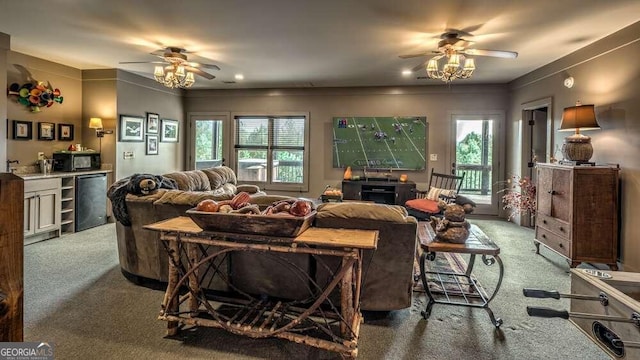 carpeted living room featuring crown molding, a healthy amount of sunlight, and ceiling fan