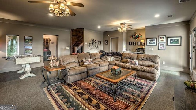 living room featuring ornamental molding, carpet flooring, and ceiling fan