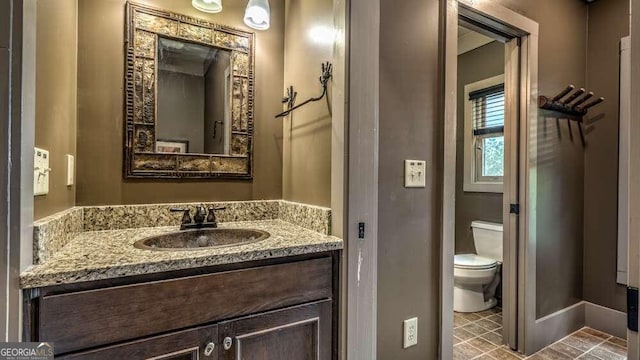 bathroom featuring vanity and toilet