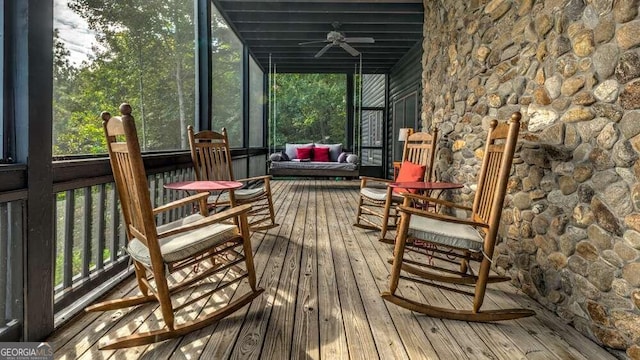 unfurnished sunroom featuring ceiling fan