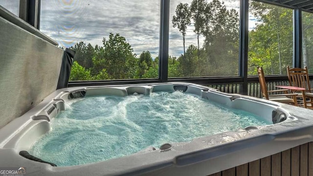 view of swimming pool with a hot tub