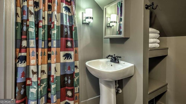 bathroom featuring vaulted ceiling and a shower with shower curtain