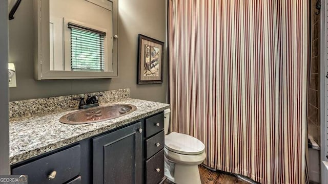 full bathroom featuring vanity, toilet, plus walk in shower, and hardwood / wood-style floors