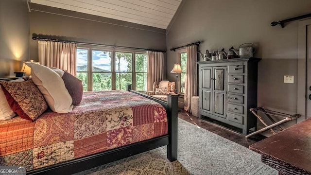 bedroom with lofted ceiling, dark wood-type flooring, and wood ceiling