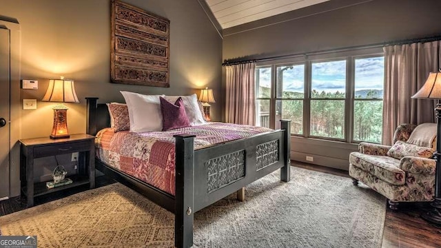 bedroom featuring hardwood / wood-style flooring and lofted ceiling