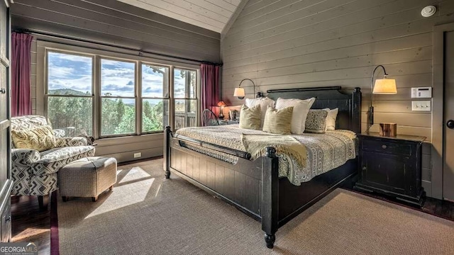 bedroom featuring wood walls and lofted ceiling