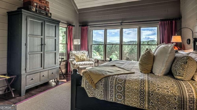 bedroom featuring dark wood-type flooring, vaulted ceiling, and wood walls