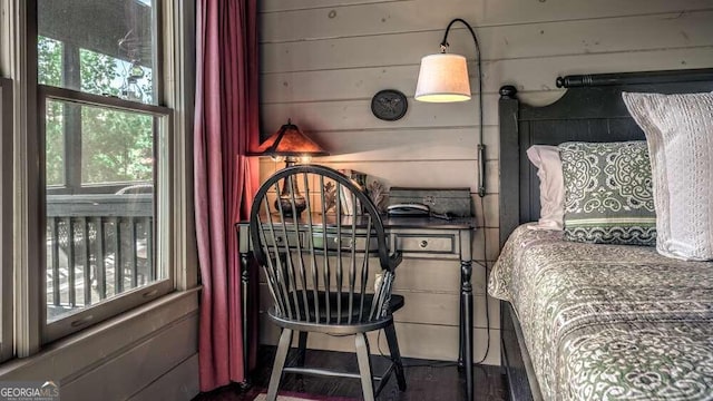 bedroom with wood walls