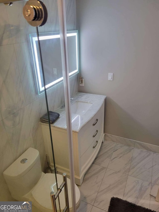 bathroom featuring tile walls, vanity, toilet, and walk in shower