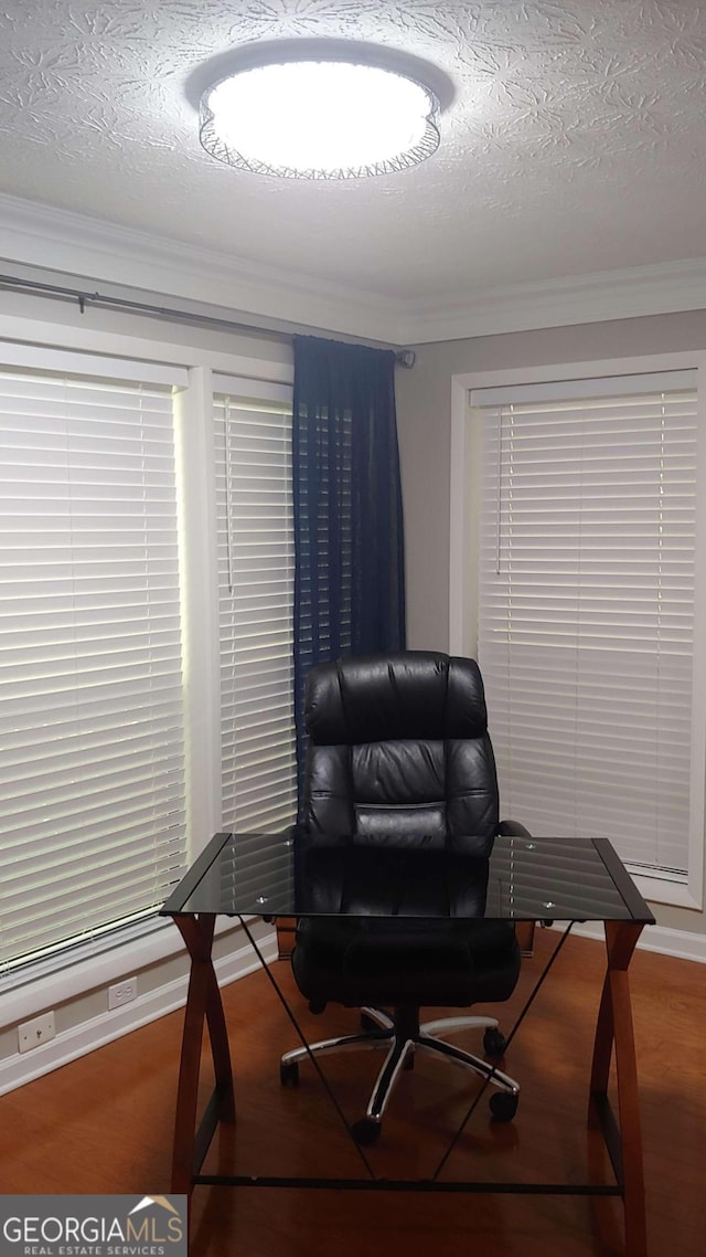 office space featuring hardwood / wood-style flooring, a textured ceiling, and ornamental molding