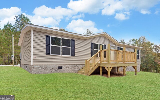 back of house featuring a deck and a yard