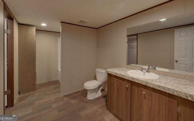 full bathroom with vanity, toilet, wood-type flooring, and independent shower and bath