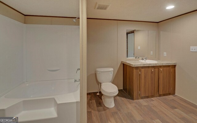 full bathroom with vanity, bathtub / shower combination, hardwood / wood-style flooring, and toilet