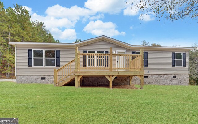 back of house with a wooden deck and a lawn