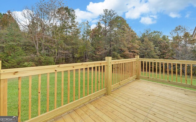 wooden deck featuring a yard