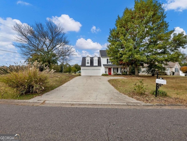 view of front of property featuring a garage and a front yard