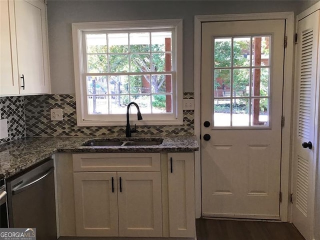 doorway featuring a sink and healthy amount of natural light