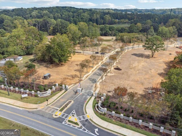 bird's eye view with a wooded view